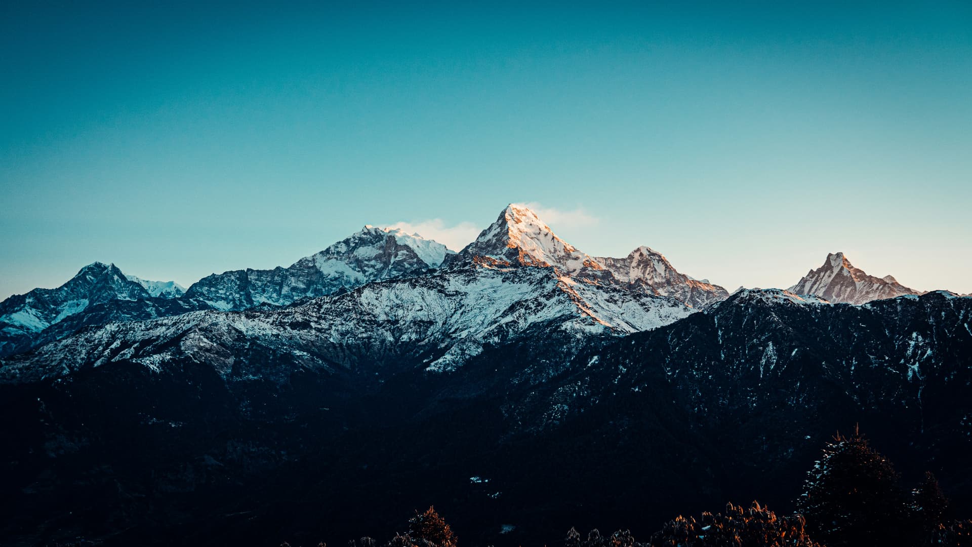 Snow-capped mountains lit by early morning light